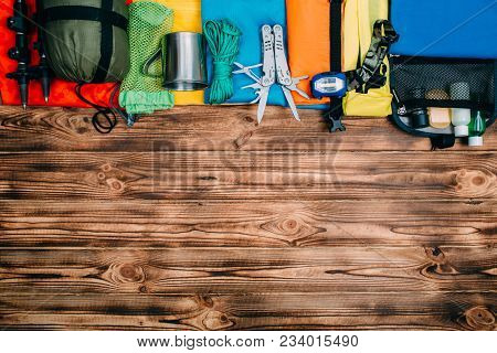 Top View Of Equipment For Hiking And Travel On Gray Background With Copy Space . Items Include Trekk