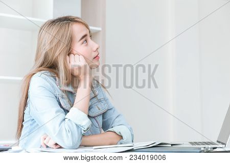 Asian Young Employee Thinking Or Inattentive Imagination Dream While Working In The Office