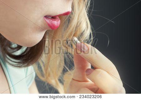 A Girl With Red Lips Takes A Pill. Taking Medicines For Colds.