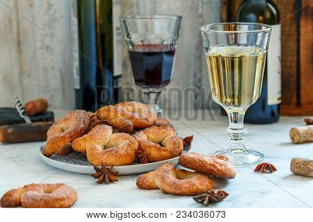 Italian Wine Donuts (ciambelle Al Vino) And Glasses With White And Red Wine On White Wooden Backgrou