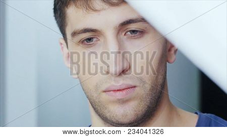 Portrait Of Man Opens The Curtains In The Morning Raises His Hands And Stretch Oneself. Young Man Op