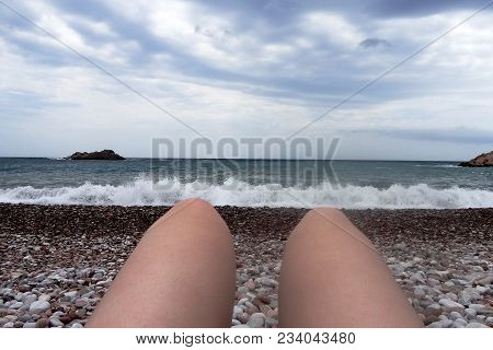 Point Of View Of Young Woman Lying On Sunbed By The Sea And Tanning. Female Legs On Chaise-longue Re