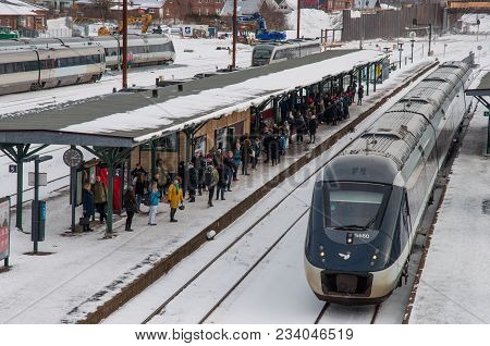 Naestved Denmark - March 1. 2018: Passengers Waiting For The Train On A Snowy Day, On The Next Track