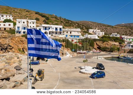 Sikinos, Greece - May 20, 2017: Greek Flag And Port Of Sikinos Island. Cyclades, Greece