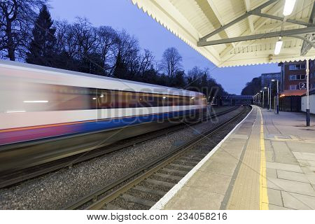 Train Passing Through A Station On A Mainline Out Of London