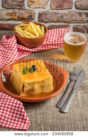 Traditional Portuguese Snack Food. Francesinha Sandwich Of Bread Cheese Pork Ham Sausages With Tomat