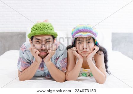 Couple Asian Man And Woman With Woolhat Together Funny Moment On White Bed