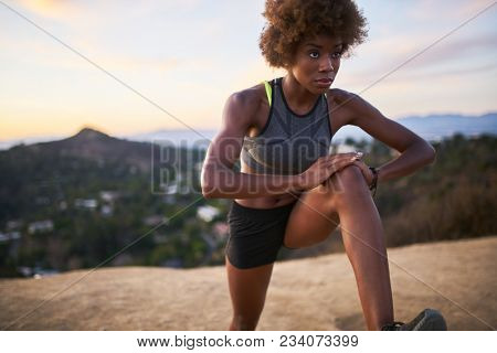 athletic african american woman doing stretches at runyon canyon