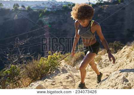 athletic african american woman walking runyon canyon             