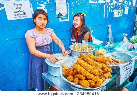 Yangon, Myanmar - February 14, 2018: The Young Food Vendors In Chinatown Market Stall Offer Deep Fri