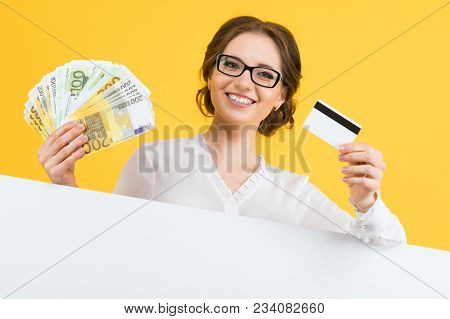 Caucasian Brunette Smiling Attractive Businesswoman In Formal Dress Holding Money And Credit Card In