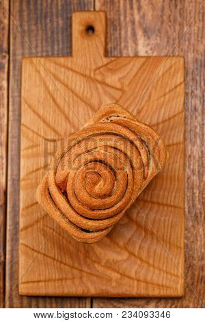 Beautiful Homemade Bread On A Textured Wooden Board. A Beautiful Combination Of The Color Of A Woode