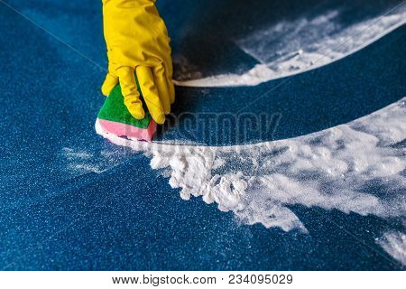 Coloured Sponges For Cleaning On A Blue Background And Yellow Hands In Gloves.