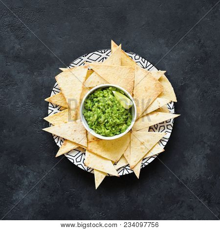 Nachos And Guacamole On A Plate, Dark Background, Square Crop
