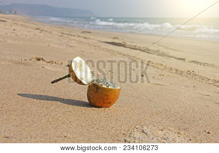 One Orange Open Passion Fruit With Seeds. Passion Fruit Closeup On The Beach, On The Sand And On The
