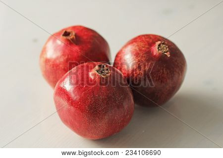 Big Ripe Red Granets Or Garnets. Fruits Of Red Ripe Pomegranate On The White Background. Vegetarian 