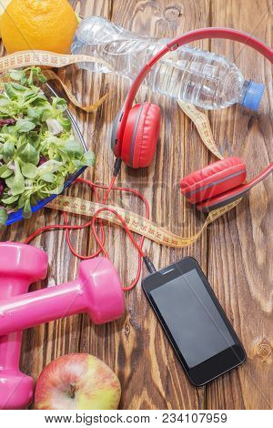 Fresh Organic Vegetables With Dumbbells On A Wooden Countertop, Copy Space, Diet, And The Concept Of