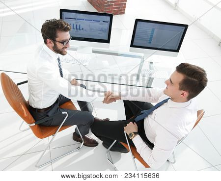 handshake financial partners sitting at Desk