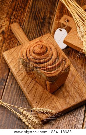 Fresh Homemade Garlic Bread On A Textured Wooden Board. Still Life With Fresh Bread And Spikelets.