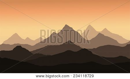 Panoramic View Of The Mountain Landscape With Fog In The Valley Below With The Alpenglow Orange Sky 