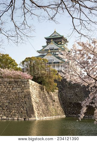 Osaka Castle Rises High Over The Castle Walls During The Height Of Spring Cherry Blossom Season