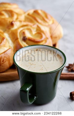 Homemade Rose Bread With Raisins On Wooden Tray, Cup Of Creamy Coffee, Anise And Cinnamon Over Vinta