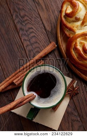 Homemade Rose Bread With Raisins On Wooden Tray, Cup Of Creamy Coffee, Anise And Cinnamon Over Vinta