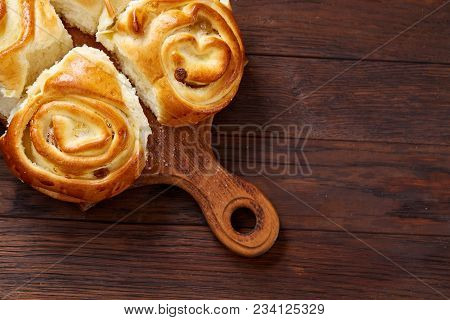 Homemade Rose Buns With Raisins On Wooden Cutting Board Over Rustic Vintage Background, Close-up, Sh