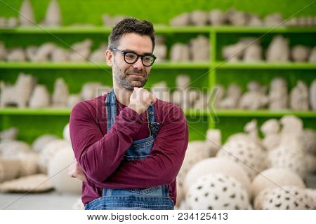 Portrait of Young Ceramist in the Bright Modern Ceramic Workshop. Small Business Concept.