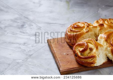 Homemade Rose Buns With Raisins On Wooden Cutting Board Over White Textured Background, Close-up, Sh