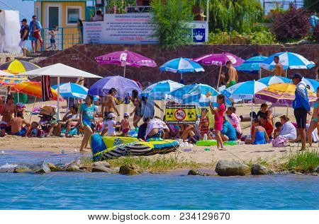 People Enjoy Hot Weather Near The Beach Of Cholpon-ata Beach , Issyk-kul Lake, Kyrgyzstan 30.07.2017