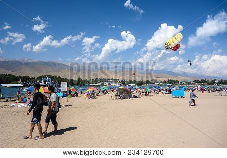 People Enjoy Hot Weather Near Cholpon-ata Beach , Issyk-kul Lake, Kyrgyzstan 30.07.2017