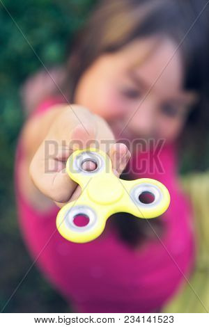 Young Girl Playy With Fidget Spinner Stress Relieving Toy. Selective Focus.