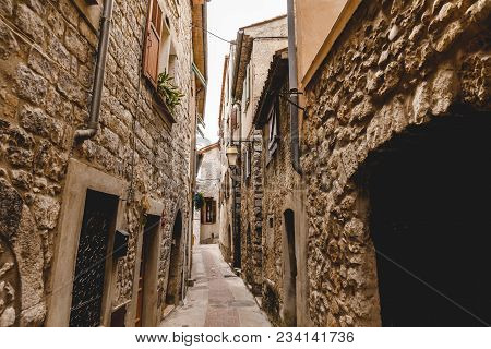 Narrow Street With Ancient Stone Buildings At Old European Town, Peille, France