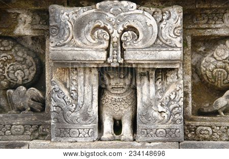 Ancient stone bas-relief with lion and parrot, Buddist temple Borobudur, Yogyakarta, Central Java, Indonesia. UNESCO world heritage site