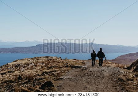 Isle Of Skye, Scotland - March 19, 2018: Couple Walking The Old Man Of Storr Walk On Skye, Mountains