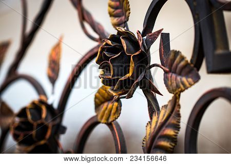 Details, Structure And Ornaments Of Forged Iron Gate. Decorative Ornamen With Roses, Made From Metal