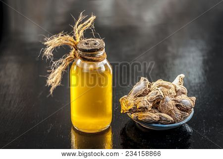 Close Up Of Ayurvedic Herb Or Folk Medicine Dried Ginger Or Zingiber Officinale With Common Cooking