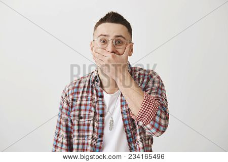 Guy Tries To Hold Laugh On Important Meeting. Portrait Of Attractive Adult Man In Glasses Chuckling 