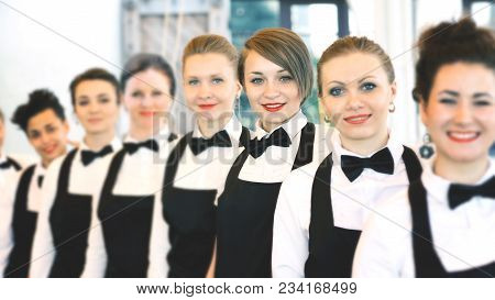 Group Of Waiters At A Prestigious Restaurant Standing In The Column In The Lobby Of The Restaurant