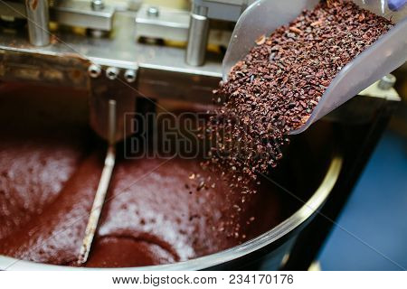 Artisan Chocolate Making, Adding Cocoa Grits In The Melanger Stone Grinder