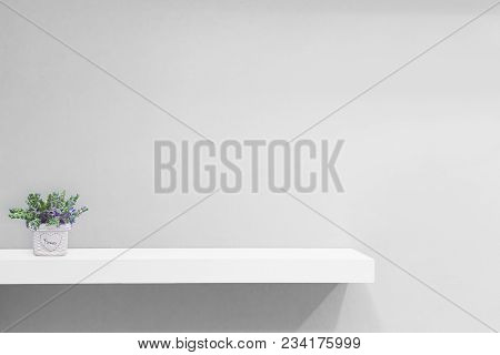 Empty White Shop Shelf, Retail Shelf On Blue Vintage Background.