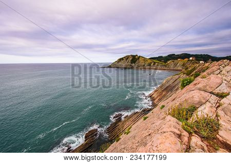 A View To The Coastine Of Basque Country Near Zumaia Fluch With Vibrant Rocks And Dramatic Sunset Sk