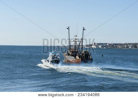 New Bedford, Massachusetts, Usa - March 31, 2018: Yacht Chill-n Passing Fishing Vessel Hustler As Th