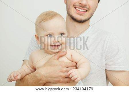 Smiling Happy Baby In Father's Hand. Little Enfant Toddler