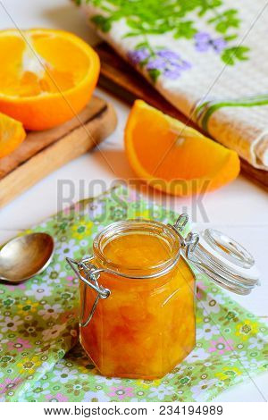 Homemade Citrus Jam. Sweet Orange Jam In A Glass Jar, Textile Napkin, Fresh Orange Slices On A Table