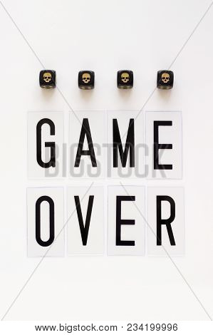 Game Over Text And Gaming Dice With Image Skull On White Background. Concept For Banners, Web Pages,