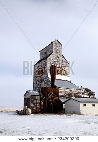 Delapitated Grain Elevator Weathered In Saskatchewan Prairie