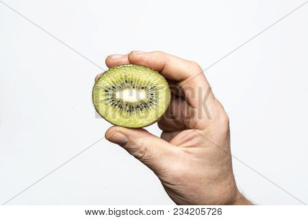 A Kiwi Fruit Cut In The Hand