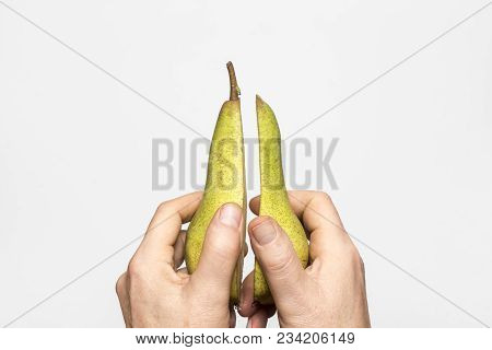 A Pear Fruit Cut In The Hands